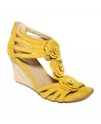 Pretty petals. The t-strap on Kenneth Cole Reaction's Cedar Leader wedge sandals is adorned with pretty flower detailing that pops against the caged straps. Pretty petals. The t-strap on Kenneth Cole Reaction's Cedar Leader wedge sandals is adorned with pretty flower detailing that pops against the caged straps.