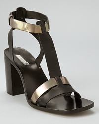 Metallic accents jazz up sleek black leather, while a chunky block heel feels right on trend. From Calvin Klein. Metallic accents jazz up sleek black leather, while a chunky block heel feels right on trend. From Calvin Klein.