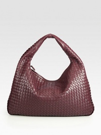 Rich woven leather design finished with a smooth shoulder strap. Shoulder strap, 4½ drop Top zip closure One inside zip pocket Suede lining 12H X 18L X 2½W Made in Italy Rich woven leather design finished with a smooth shoulder strap. Shoulder strap, 4½ drop Top zip closure One inside zip pocket Suede lining 12H X 18L X 2½W Made in Italy