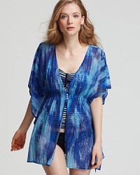 Take your love of prints poolside with this printed tunic from PilyQ. With delicate smocking and floaty sleeves, this cover up lends a bohemian vibe to your sunbathing routine.