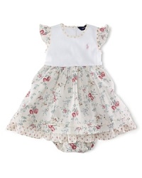 A pretty day dress is styled with a charming floral print and contrasting trim. A pretty day dress is styled with a charming floral print and contrasting trim.