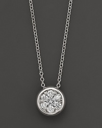 A stunning diamond cluster is bezel-set in 14K white gold.
