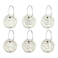 This elegant assortment of weighty ceramic wine charms each feature Juliska's signature thread-and-berry detailing. Numbered one through six, they're finished in a rich, warm white hue with slightly distressed appearance. This elegant assortment of weighty ceramic wine charms each feature Juliska's signature thread-and-berry detailing. Numbered one through six, they're finished in a rich, warm white hue with slightly distressed appearance.