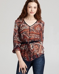 A cinched drawstring waist flatters the frame on this Sam & Lavi tunic, decorated with a lively eclectic print. A cinched drawstring waist flatters the frame on this Sam & Lavi tunic, decorated with a lively eclectic print.