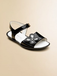 Polished patent leather in a graceful design with a glittery flower on the front strap for added sparkle and shine.Double grip-tape ankle strapLeather upperLeather liningRubber solePadded insoleImported Polished patent leather in a graceful design with a glittery flower on the front strap for added sparkle and shine.Double grip-tape ankle strapLeather upperLeather liningRubber solePadded insoleImported