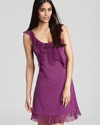 A sleeveless chemise with cascading ruffles along neckline and hem. A sleeveless chemise with cascading ruffles along neckline and hem.
