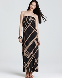 Capitalizing on this season's tribal trend, this DKNYC maxi dress sends your style on a wild ride with an oversized graphic print and a floor-skimming silhouette. Capitalizing on this season's tribal trend, this DKNYC maxi dress sends your style on a wild ride with an oversized graphic print and a floor-skimming silhouette.