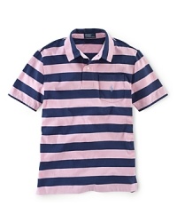 A classic polo rendered in striped jersey-knit cotton for a preppy look. A classic polo rendered in striped jersey-knit cotton for a preppy look.