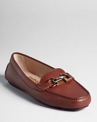 Luxe leather and a golden logo accent lend elegance to a streamlined, classic loafer from Salvatore Ferragamo. Luxe leather and a golden logo accent lend elegance to a streamlined, classic loafer from Salvatore Ferragamo.