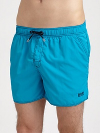 Stylish swim trunks are both sporty and functional, rendered in quick-drying nylon.Elastic drawstring waistSide slash, back flap pocketsInseam, about 4PolyamideMachine washImported Stylish swim trunks are both sporty and functional, rendered in quick-drying nylon.Elastic drawstring waistSide slash, back flap pocketsInseam, about 4PolyamideMachine washImported