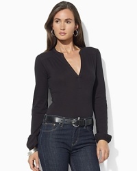 Sleek stretch jersey forms the foundation of a chic split-neck top. Sleek stretch jersey forms the foundation of a chic split-neck top.
