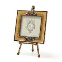 Stylish frame and easel set featuring tan colored hand-enameling. Adorned with hand-set Swarovski crystals, tiger's eye, a decorative enamel back and elegantly finished with a faux pearl atop easel. Stylish frame and easel set featuring tan colored hand-enameling. Adorned with hand-set Swarovski crystals, tiger's eye, a decorative enamel back and elegantly finished with a faux pearl atop easel.