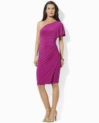 A flirty flutter sleeve imparts feminine charm to a sophisticated one-shoulder silhouette, crafted in fluid matte jersey with soft ruching for a flattering fit. A flirty flutter sleeve imparts feminine charm to a sophisticated one-shoulder silhouette, crafted in fluid matte jersey with soft ruching for a flattering fit.