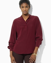 Rendered in skin-caressing silk, a chic tunic is crafted with dolman sleeves for modern appeal. Rendered in skin-caressing silk, a chic tunic is crafted with dolman sleeves for modern appeal.