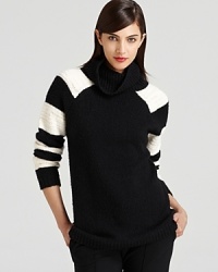 In a modern black and white black palette, this Halston Heritage turtleneck strikes at a distance with boldly striped sleeves and an exaggerated collar. In a modern black and white black palette, this Halston Heritage turtleneck strikes at a distance with boldly striped sleeves and an exaggerated collar.