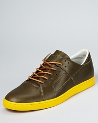 Get creative with your casual look. The Tucco updates the sneaker with a burnished leather upper, suede laces and a boldly contrasting rubber sole. Get creative with your casual look. The Tucco updates the sneaker with a burnished leather upper, suede laces and a boldly contrasting rubber sole.