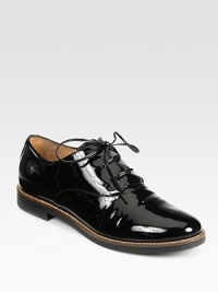 A menswear-inspired silhouette in patent leather with charming laces. Stacked heel, 1 (25mm)Patent leather upperLeather liningRubber solePadded insoleMade in Italy