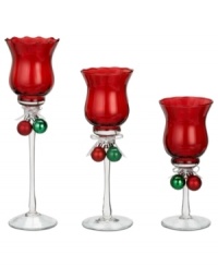 In opulent red glass, these votive holders from Ganz give a festive glow to your home this holiday season. Each holder features a duo of classic Christmas ball ornaments tied with ribbon around the stem. In opulent red glass, these votive holders from Ganz give a festive glow to your home this holiday season. Each holder features a duo of classic Christmas ball ornaments tied with ribbon around the stem.