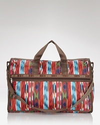 Updated in a bold print, LeSportsac's do-it-all duffel bag is crafted from nylon to be your trusty travel companion. Updated in a bold print, LeSportsac's do-it-all duffel bag is crafted from nylon to be your trusty travel companion.