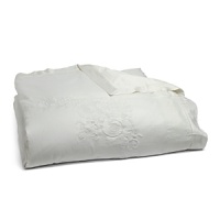 This luxurious all-white bedding ensemble incorporates couture-inspired details - from intricate floral embroidery to elegant silk matelasse - for a feminine vision of modern romance. This luxurious all-white bedding ensemble incorporates couture-inspired details - from intricate floral embroidery to elegant silk matelasse - for a feminine vision of modern romance.