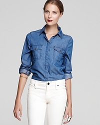 Rooted in western style, a classic chambray button down remains a timeless fall favorite--this Sanctuary shirt is easy to dress up or down and merges an iconic country look with cosmopolitan chic. Rooted in western style, a classic chambray button down remains a timeless fall favorite--this Sanctuary shirt is easy to dress up or down and merges an iconic country look with cosmopolitan chic.