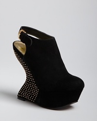 Strikingly sculptural platform wedges are accented by a galaxy of mini studs in these future-meets-wow slingbacks by Dolce Vita. Strikingly sculptural platform wedges are accented by a galaxy of mini studs in these future-meets-wow slingbacks by Dolce Vita.