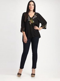 Floral embroidery offers charming pops of color on this tunic. You will love its relaxed fit and flattering silhouette.V-necklineThree-quarter sleevesEmbroidered detailsAsymmetrical hemAbout 30 from shoulder to hemRayonMachine washImported Floral embroidery offers charming pops of color on this tunic. You will love its relaxed fit and flattering silhouette.V-necklineThree-quarter sleevesEmbroidered detailsAsymmetrical hemAbout 30 from shoulder to hemRayonMachine washImported