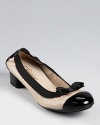 With patent accents and an easy-to-walk-in heel, this classic ballet silhouette from Salvatore Ferragamo is simply timeless.