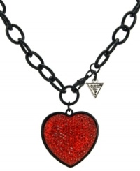 Revel in romance. GUESS's dramatic heart pendant stands out with bright red crystals against a black-plated mixed metal setting and toggle clasp. Approximate length: 18 inches. Approximate drop: 1-1/2 inches. Revel in romance. GUESS's dramatic heart pendant stands out with bright red crystals against a black-plated mixed metal setting and toggle clasp. Approximate length: 18 inches. Approximate drop: 1-1/2 inches.