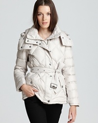Master this season's sporty-chic aesthetic in a down Burberry Brit coat, touting a generous puffer silhouette for a stylish look that moves from ski slopes to city blocks. Master this season's sporty-chic aesthetic in a down Burberry Brit coat, touting a generous puffer silhouette for a stylish look that moves from ski slopes to city blocks.