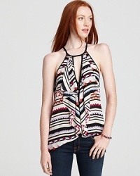 Ruffles cascade around a sexy keyhole cutout on this halter top, bringing a flirty counterpoint to the bold tribal print. Ruffles cascade around a sexy keyhole cutout on this halter top, bringing a flirty counterpoint to the bold tribal print.