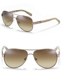 Make a chic, sophisticated statement with Tory Burch's iconic aviator sunglasses. Logos at the temples add a signature finish. Make a chic, sophisticated statement with Tory Burch's iconic aviator sunglasses. Logos at the temples add a signature finish.