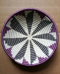 Support women artisans in Rwanda simply by decorating. Naturally dyed sisal is hand-woven over bundled sweet grass to produce this gorgeous purple and gray basket. Hang it, fill it or simply place it on a table for everyone to admire. Support women artisans in Rwanda simply by decorating. Naturally dyed sisal is hand-woven over bundled sweet grass to produce this gorgeous purple and gray basket. Hang it, fill it or simply place it on a table for everyone to admire.