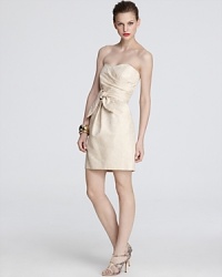 A subtle metallic sheen glams up this Shoshanna strapless dress, complete with an oversize tie at the waist for an added dose of drama. A subtle metallic sheen glams up this Shoshanna strapless dress, complete with an oversize tie at the waist for an added dose of drama.