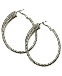 Sophistication reigns on these sparkling clutchless hoops from GUESS. Pave crystals adorn a classic earring silhouette. Crafted in silver tone mixed metal. Approximate drop: 2-1/4 inches. Sophistication reigns on these sparkling clutchless hoops from GUESS. Pave crystals adorn a classic earring silhouette. Crafted in silver tone mixed metal. Approximate drop: 2-1/4 inches.