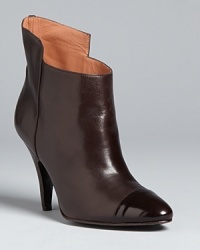 With eye-catching cuffs and patent cap toes, these high heel booties are polished enough for work and downtown nights out; from Sigerson Morrison. With eye-catching cuffs and patent cap toes, these high heel booties are polished enough for work and downtown nights out; from Sigerson Morrison.