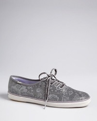 Your favorite Keds Champion sneakers get dressed up in metallic lace-printed suede and luxe satin linings, tied up with plush velvet laces-fit for a queen. Your favorite Keds Champion sneakers get dressed up in metallic lace-printed suede and luxe satin linings, tied up with plush velvet laces-fit for a queen.