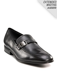 Sleek and stylish slip-on dress shoes with leather strap and buckle detail at top. Round toe. Gancini insignia etched on buckle and heel. Leather sole with slightly stacked heel. Sleek and stylish slip-on dress shoes with leather strap and buckle detail at top. Round toe. Gancini insignia etched on buckle and heel. Leather sole with slightly stacked heel.