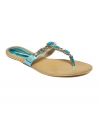 Dripping in jewels. Nine West's Evania flat thong sandals feature beautiful rhinestones along the vamp. They'll add instant glam to everything from bathing suits to dresses. Dripping in jewels. Nine West's Evania flat thong sandals feature beautiful rhinestones along the vamp. They'll add instant glam to everything from bathing suits to dresses.