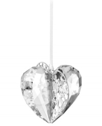 Silvertone metal pierced with intricate patterns and sparkling chatons adds even more splendor to this exquisite Swarovski crystal heart ornament. Silvertone metal pierced with intricate patterns and sparkling chatons adds even more splendor to this exquisite Swarovski crystal heart ornament.