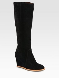 A tall cold weather staple rendered in buttery suede and resting on a comfortable wedge. Self-covered wedge, 3¼ (80mm)Shaft, 15¾Leg circumference, 14Suede upperBack zipLeather liningRubber solePadded insoleImported A tall cold weather staple rendered in buttery suede and resting on a comfortable wedge. Self-covered wedge, 3¼ (80mm)Shaft, 15¾Leg circumference, 14Suede upperBack zipLeather liningRubber solePadded insoleImported