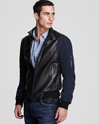 On this prized Elie Tahari jacket, the leather base gives way to contrast nylon sleeves for a unique, sporty design that updates your look and makes a modern statement. On this prized Elie Tahari jacket, the leather base gives way to contrast nylon sleeves for a unique, sporty design that updates your look and makes a modern statement.