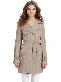 This essential layer exudes workweek chic with its double breasted front and gorgeous rumpled texture.Notched collar converts to point collar Concealed double breasted button-front Single gun flap Long buckled belt ties at front Vertical welt pockets Back rain shield Inverted center back pleat with button closure at hem Cotton lining About 32½ from shoulder to hem 66% nylon/34% cotton; dry clean Imported This essential layer exudes workweek chic with its double breasted front and gorgeous rumpled texture.Notched collar converts to point collar Concealed double breasted button-front Single gun flap Long buckled belt ties at front Vertical welt pockets Back rain shield Inverted center back pleat with button closure at hem Cotton lining About 32½ from shoulder to hem 66% nylon/34% cotton; dry clean Imported