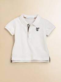 A classic polo in breezy pique with Burberry check accents.Ribbed polo collarShort sleeves with ribbed cuffsButton placket with check inside trimEmbroidered logo on chestSide slit hem with longer-in-back tennis tailsCottonMachine washImported Please note: Number of buttons may vary depending on size ordered. A classic polo in breezy pique with Burberry check accents.Ribbed polo collarShort sleeves with ribbed cuffsButton placket with check inside trimEmbroidered logo on chestSide slit hem with longer-in-back tennis tailsCottonMachine washImported Please note: Number of buttons may vary depending on size ordered.