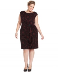 This plus size lace-print dress by Jones New York is gathered at the waist with a jeweled brooch as a fabulous finishing touch.