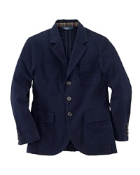 The three-button Langley sport coat is rendered in season-spanning cotton chino and finished with madras plaid lining the collar for a pop of preppy color. The three-button Langley sport coat is rendered in season-spanning cotton chino and finished with madras plaid lining the collar for a pop of preppy color.
