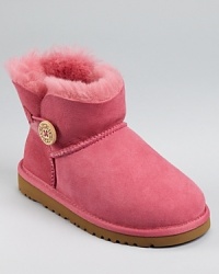 A trimmer take on UGG's classic, this medium-rise suede boot is trimmed with shearling and accented with a logo button at the side. A trimmer take on UGG's classic, this medium-rise suede boot is trimmed with shearling and accented with a logo button at the side.