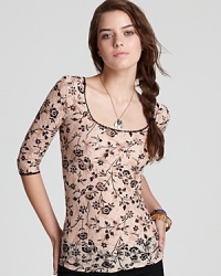 A pretty printed lace top by Free People with unexpected criss-cross black lace strings in back. A pretty printed lace top by Free People with unexpected criss-cross black lace strings in back.
