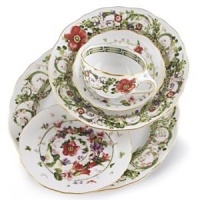 Flower Fantasy cream soup cup and saucer by Versace by Rosenthal. Derived from one of the fashion houses archival prints, this exuberant collection evokes the romance and promise of spring as hand-painted renderings of meadow herbs, sweet-scented flowers and even four-leaf clovers intermingle in a subtle yet lively design.