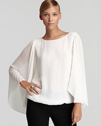 Brimming with ethereal elegance, this VINCE CAMUTO top makes a dramatic entrance with generously pleated sleeves. Slip it on and prepare stand out. Brimming with ethereal elegance, this VINCE CAMUTO top makes a dramatic entrance with generously pleated sleeves. Slip it on and prepare stand out.